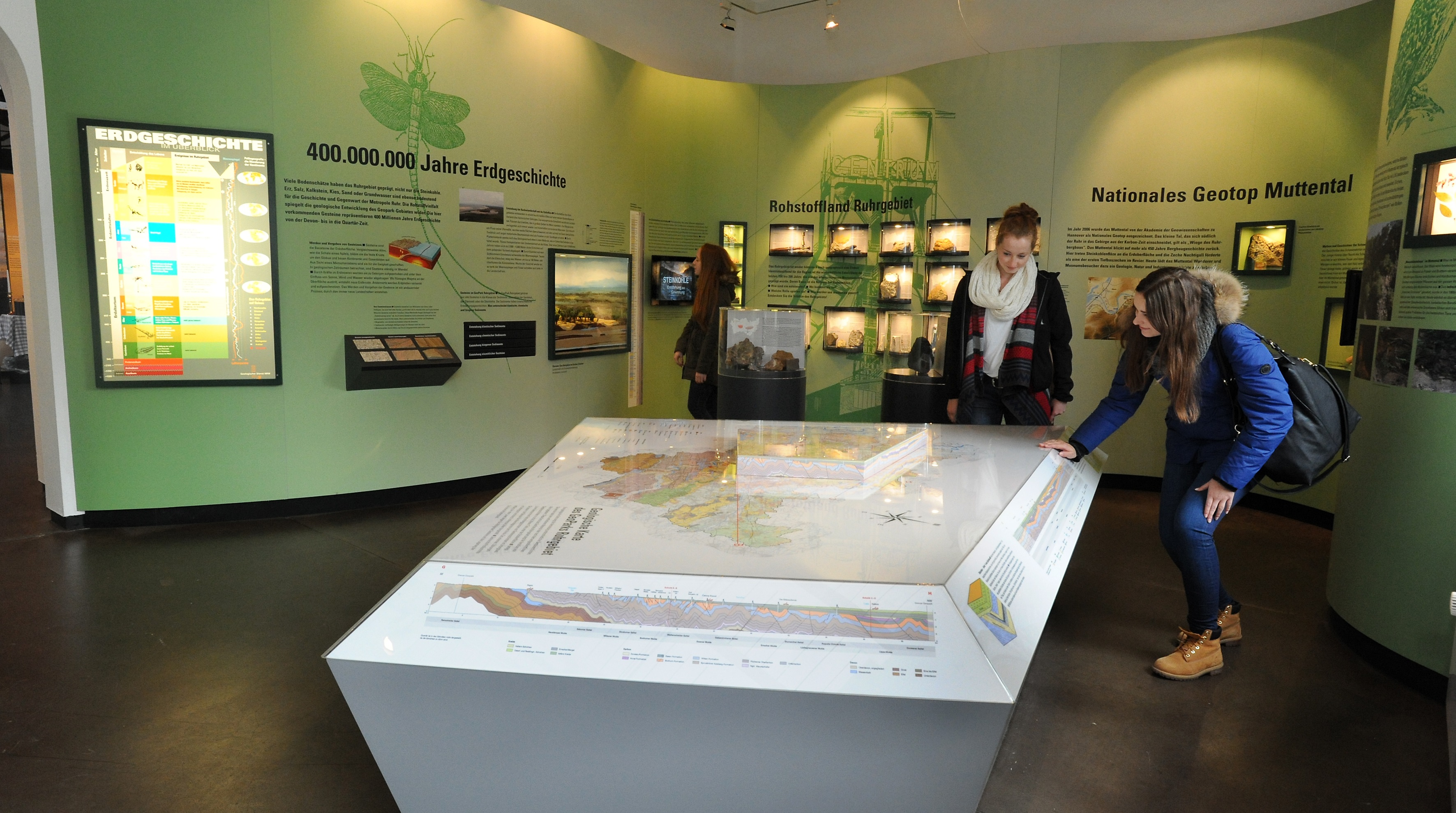 Besucher an Tisch mit geologischer Karte